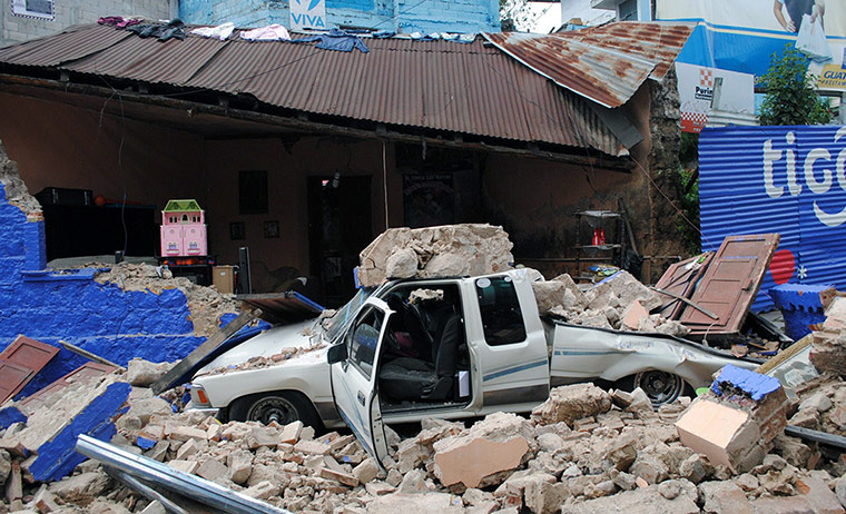 Guatemala Earthquake: A car remains under the ruins of a colla