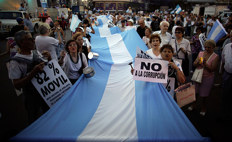 24 hours in pictures: People march with an Argentine flag during an anti-government demonstration