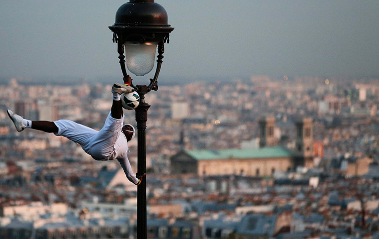 24 hours in pictures: A football freestyler performs on a light pole 
