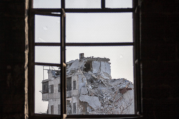 From The Agencies: A damaged building is seen through a window after intense battles