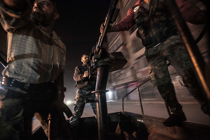 From The Agencies: A mobile rebel unit with a truck mounted gun moves through rebel streets