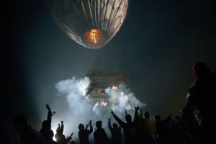 20 Photos: People celebrate as a balloon carrying fireworks takes off in Myanmar