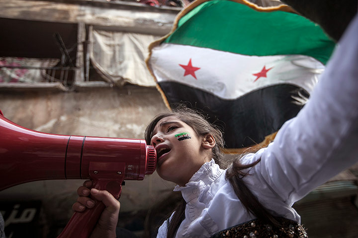 20 Photos: A Syrian girl chants during a demonstration after Friday prayers in Aleppo