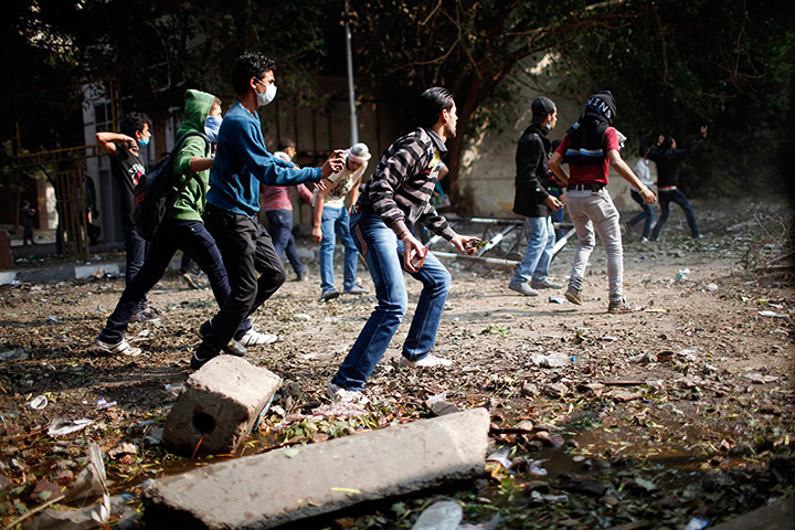 20 Photos: Anti-Mursi protesters throw stones during clashes at Tahrir square in Cairo