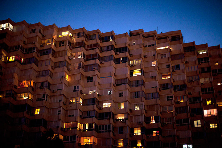 24 Hours: A man looks out from the window of his flat in Spain