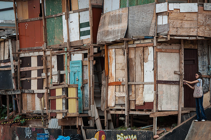 24 Hours: A woman locks her home at Paraisopolis shantytown in Sao Paulo