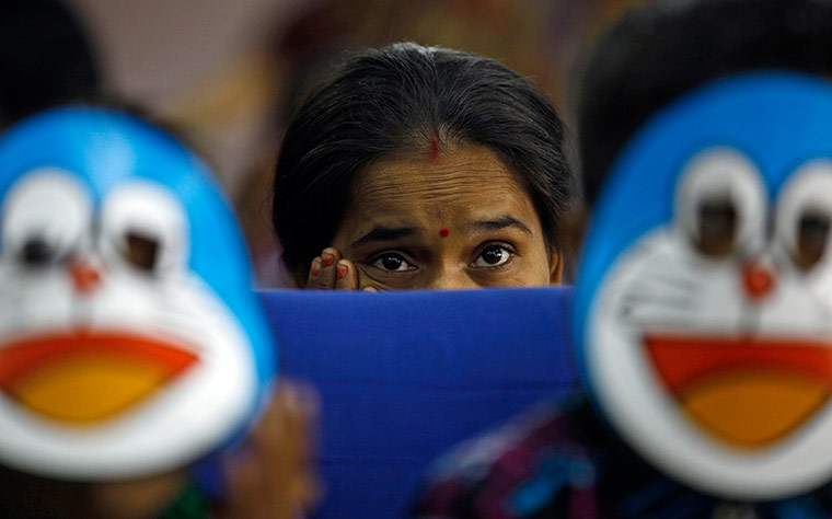24 Hours: A woman watches a performanc to mark World AIDS Day