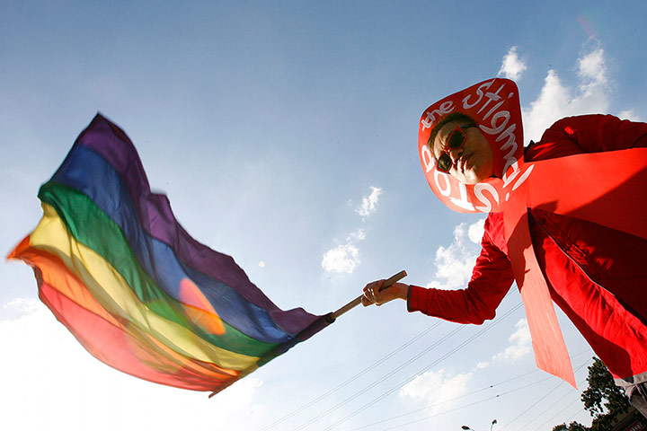 World Aids Day: Manila, Philippines: A man waves a rainbow flag