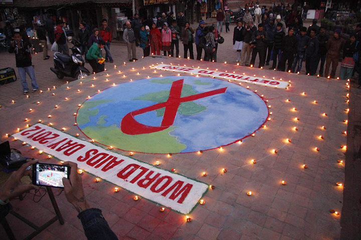 World Aids Day: Kathmandu, Nepal: A red ribbon has candles placed around it