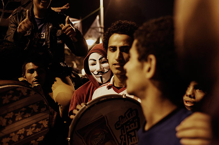 Egypt protests: An Egyptian man wearing an 'Anonymous' mask takes part in a demonstration