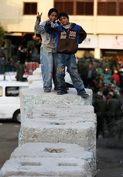 Egypt protests: Two protesters flash victory signs as they pose