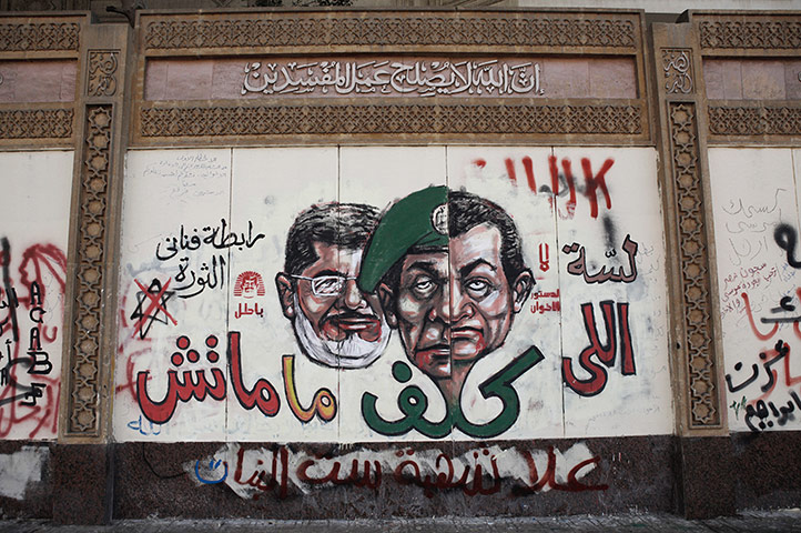 Egypt protests: Graffiti likening president Morsi to Council of the Armed Forces leader