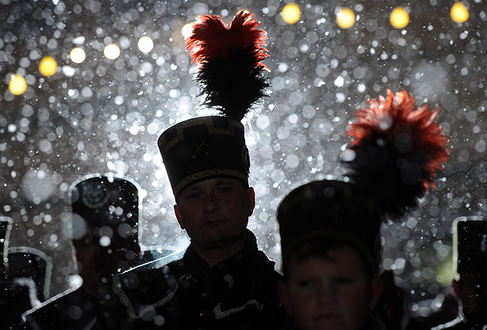 24 hours: Schneeberg, Germany: Snow falls onto the hats of miners 