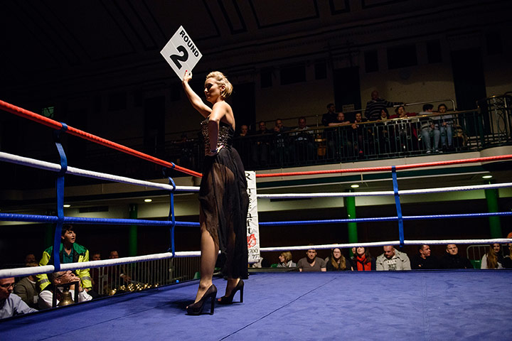 Lucy Fry gallery: A ring girl holds up a card before the start of round two