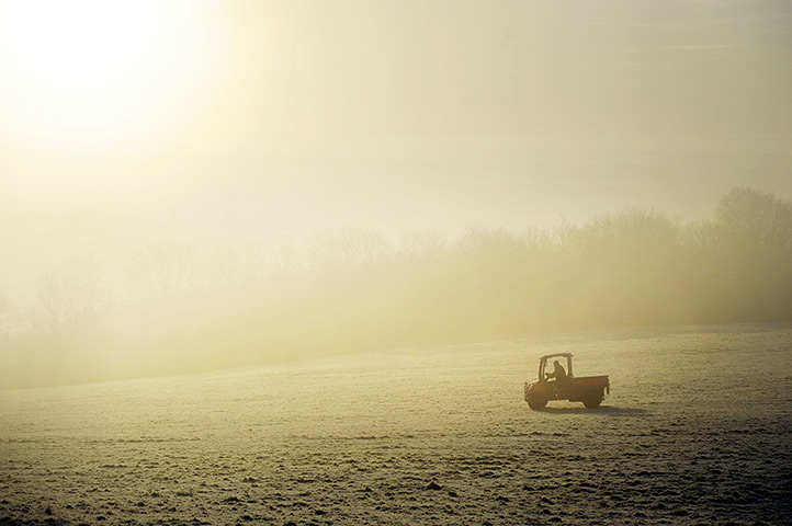 Cold weather: A person drives an all terrain vehicle through the fog near Wells