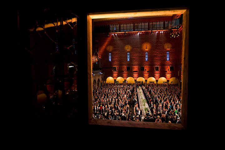 24 hours in pictures: Nobel laureates are seen through an interior window