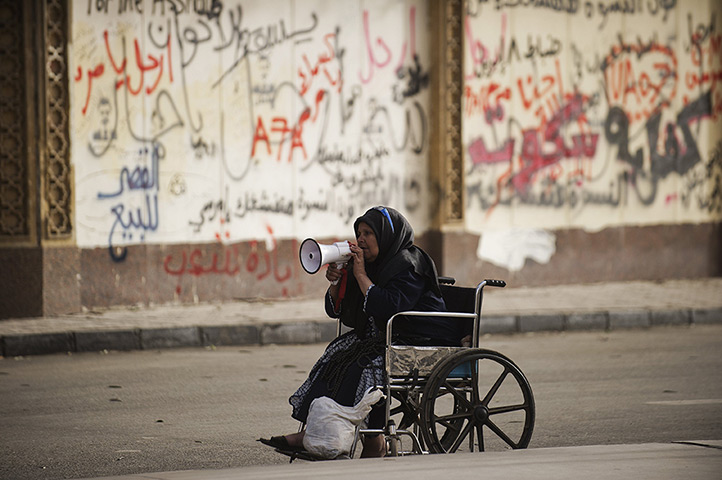 24 hours in pictures: A wheel chair-bound woman shouts political slogans in cairo