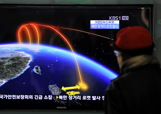 North Korea missile: A man watches a TV screen broadcasting news on North Korea's rocket launch