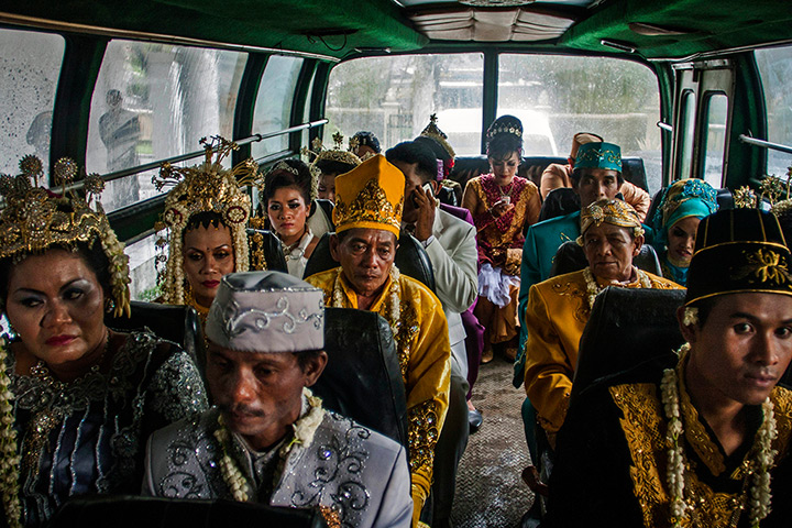 24 hours: Yogyakarta, Indonesia: Brides and grooms sit inside a bus 