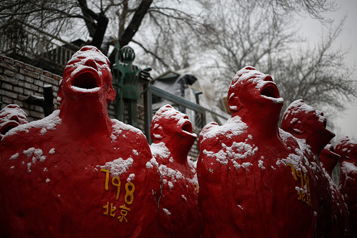 24 hours: Beijing, China: Snow falls on sculptures