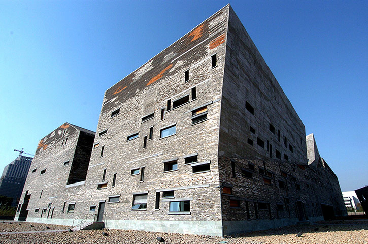 Wang Shu Architect: An angular stone building in China with random windows