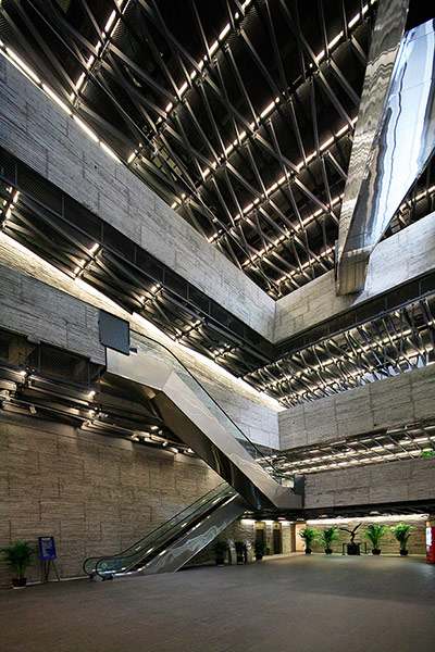 Wang Shu, architect: a shiny metal highly designed staircase in museum interior