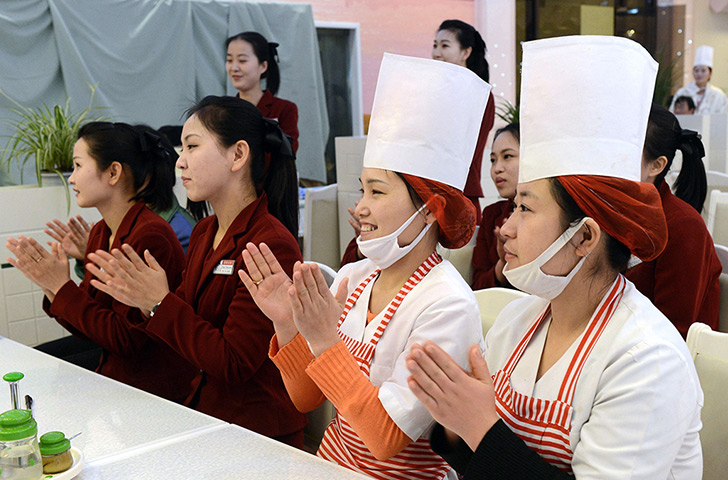 Korea rocket launch: North Korean employees at a restaurant applaud