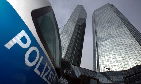 A police car stands in front of the Deutsche Bank headquarters in Frankfurt