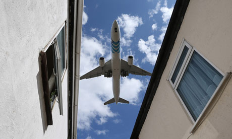 A plane comes into land over houses near Heathrow