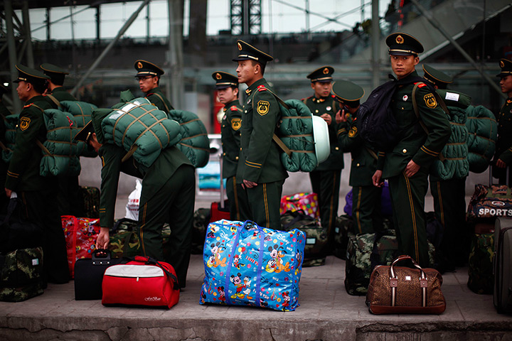 24 hours: Nanjing, China: Paramilitary policemen wait at a train station 