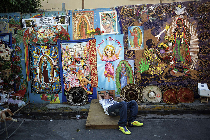 24 hours: San Salvador, El Salvador: A street vendor with religious merchandise 