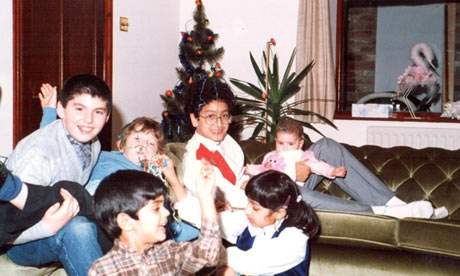 Remona Aly's family at Christmas, the tree in the background and Remona bottom right.