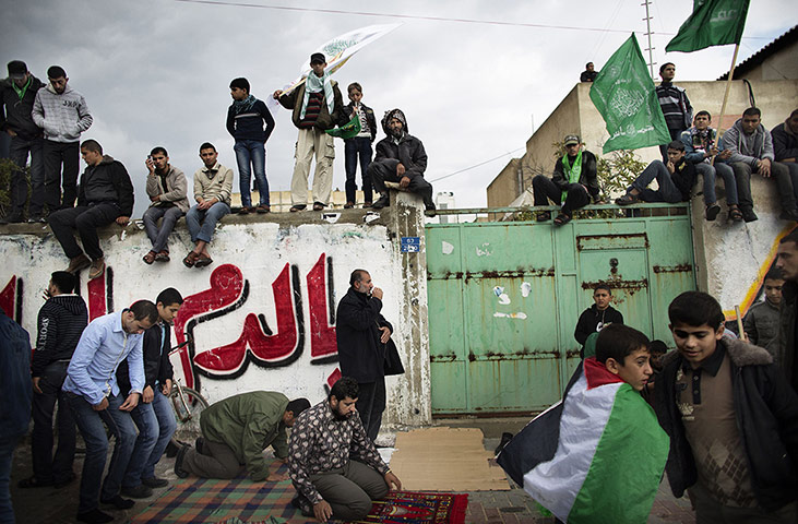 20 Photos: Palestinians pray during a rally to mark the 25th anniversary of Hamas