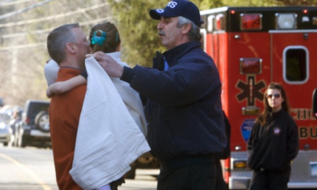 A young girl is given a blanket after being evacuated from Sandy Hook school.