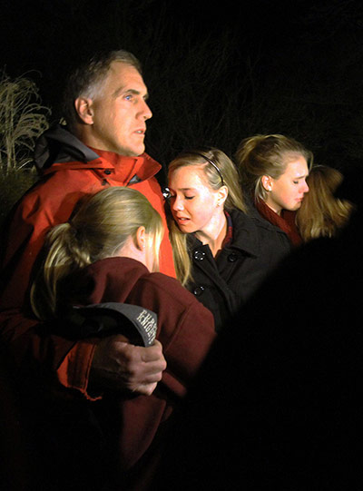 Sandy Hook aftermath: A man hugs his young daughters