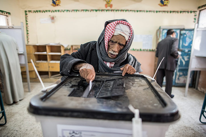 Egypt Referendum: An Egyptian man casts his vote during the referendum on the new constitution