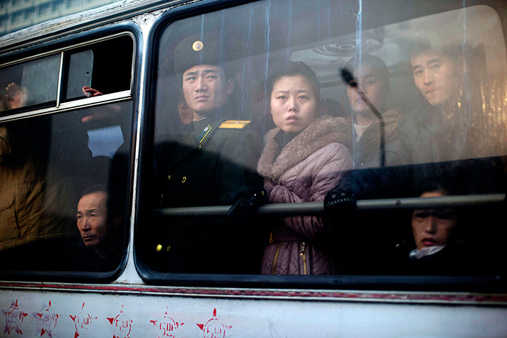 24 hours in pictures: North Korean residents and a soldier take public transport