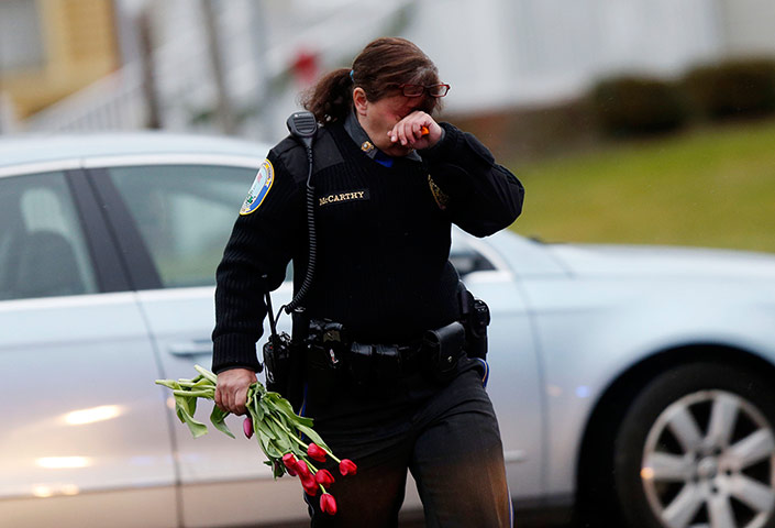 Sandy Hook: Newtown Police Officer Maryhelen McCarthy brings flowers 