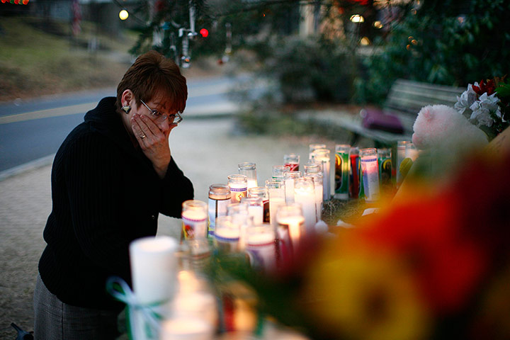 Sandy Hook: A woman reacts at a memorial near Sandy Hook Elementary School 