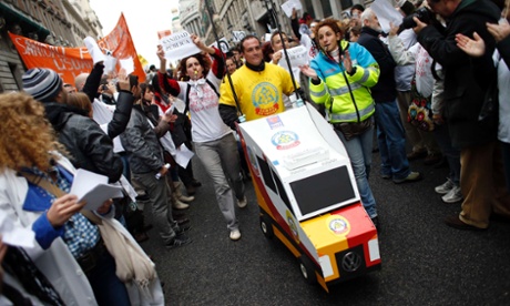 A man pushes a replica model of an ambulance as he joins health workers during a march against austerity measures in Madrid, 16 December 2012. 