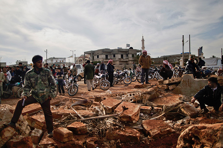 24 hours: Maaret Misreen, Syria: Syrians wait outside a bakery shop to buy bread 