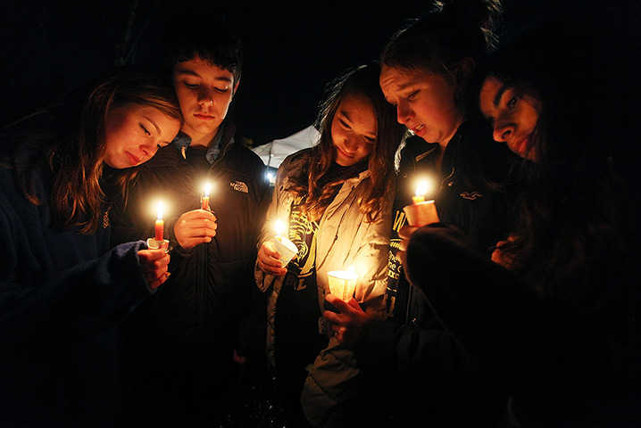 24 hours: Newtown, Connecticut. US:  Residents hold candles