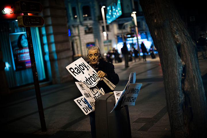 24 hours in pictures:  A man places banners in a  bin after leaving a Union demonstration