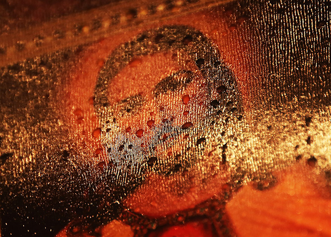 24 hours in pictures: Raindrops rest on a Jesus painting at a memorial in Newtown