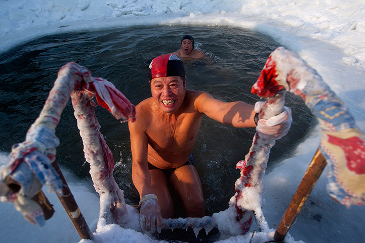 24 hours in pictures:  A winter swimmer Gong Shulin finishes a swim