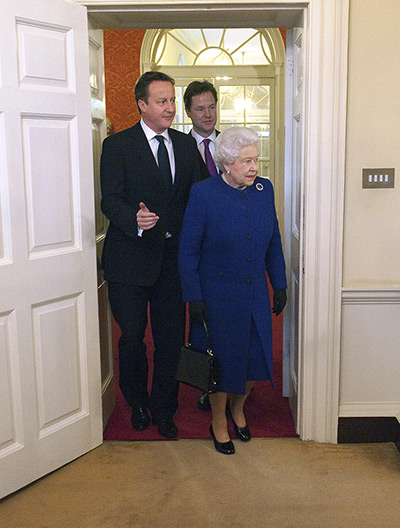 The Queen at No 10: Queen Elizabeth II is led inside by Prime Minister David Cameron