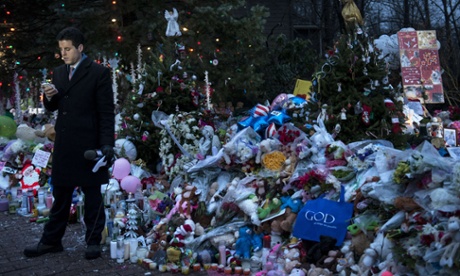 A TV reporter waits to do a standup report from a road side memorial dedicated to the victims of the shooting at Sandy Hook Elementary School in Newtown, Connecticut. Students in Newtown, excluding Sandy Hook Elementary School, returned to school for the first time since last Friday