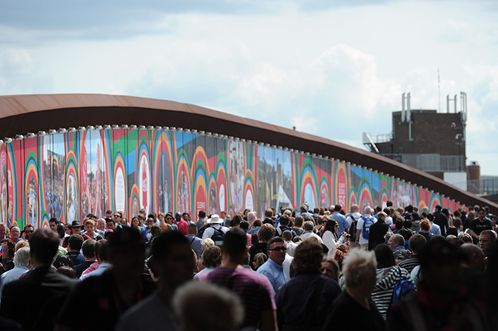 Year in business: People cross a footbridge from the Stratford train station