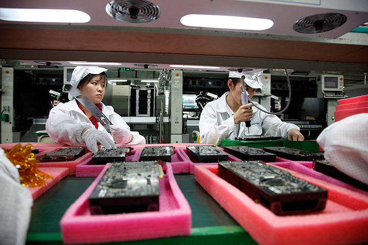 Year in business: Employees work on the assembly line at Hon Hai Group's Foxconn plant