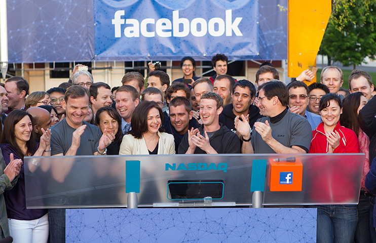 Year in business: Facebook founder and CEO Mark Zuckerberg claps 